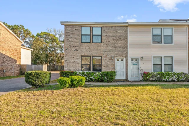 a view of a car park front of a house