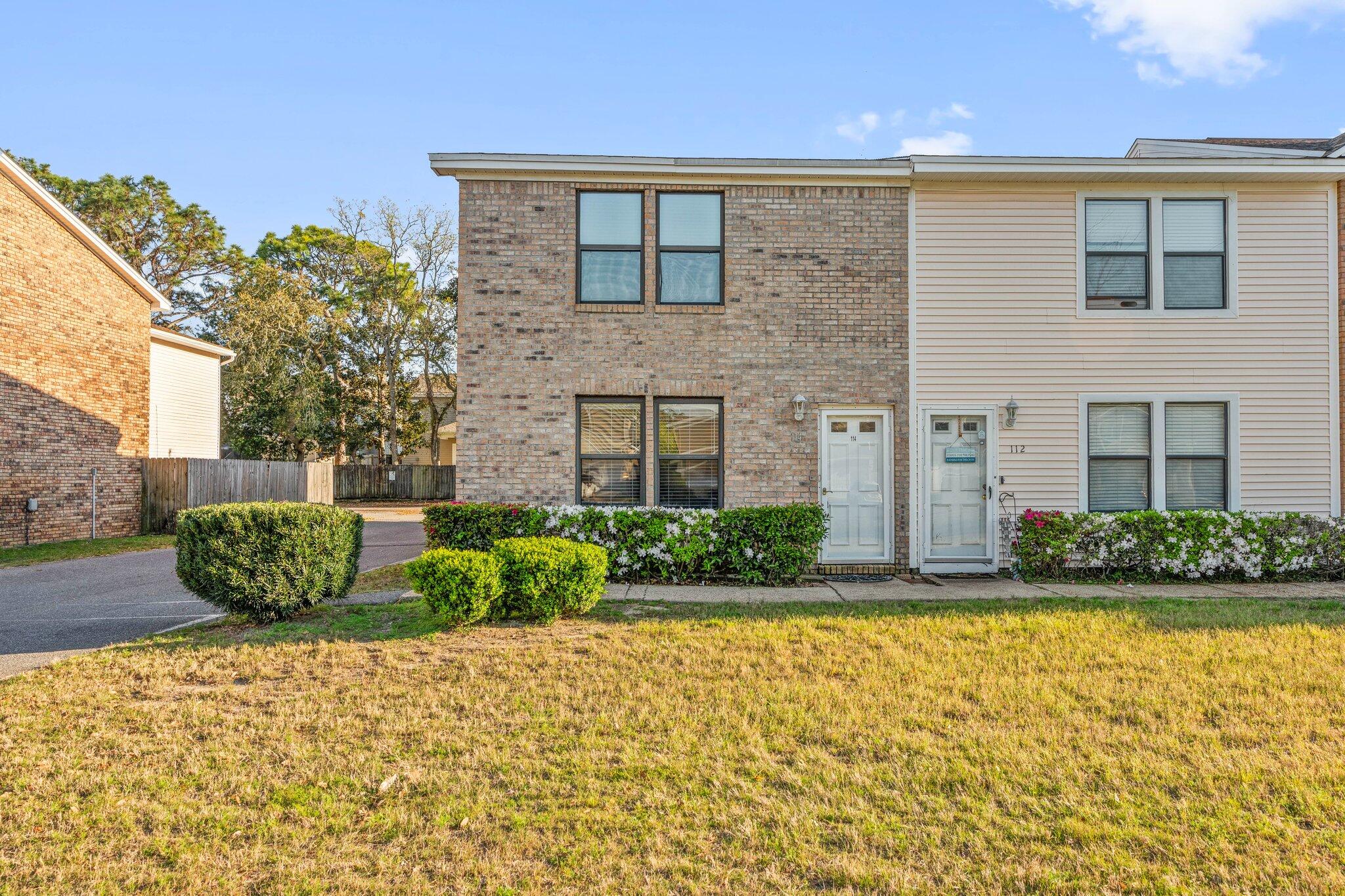 114 4th Avenue Shalimar, FL 32579 - Photo 44 of 59 a front view of a house with a garden