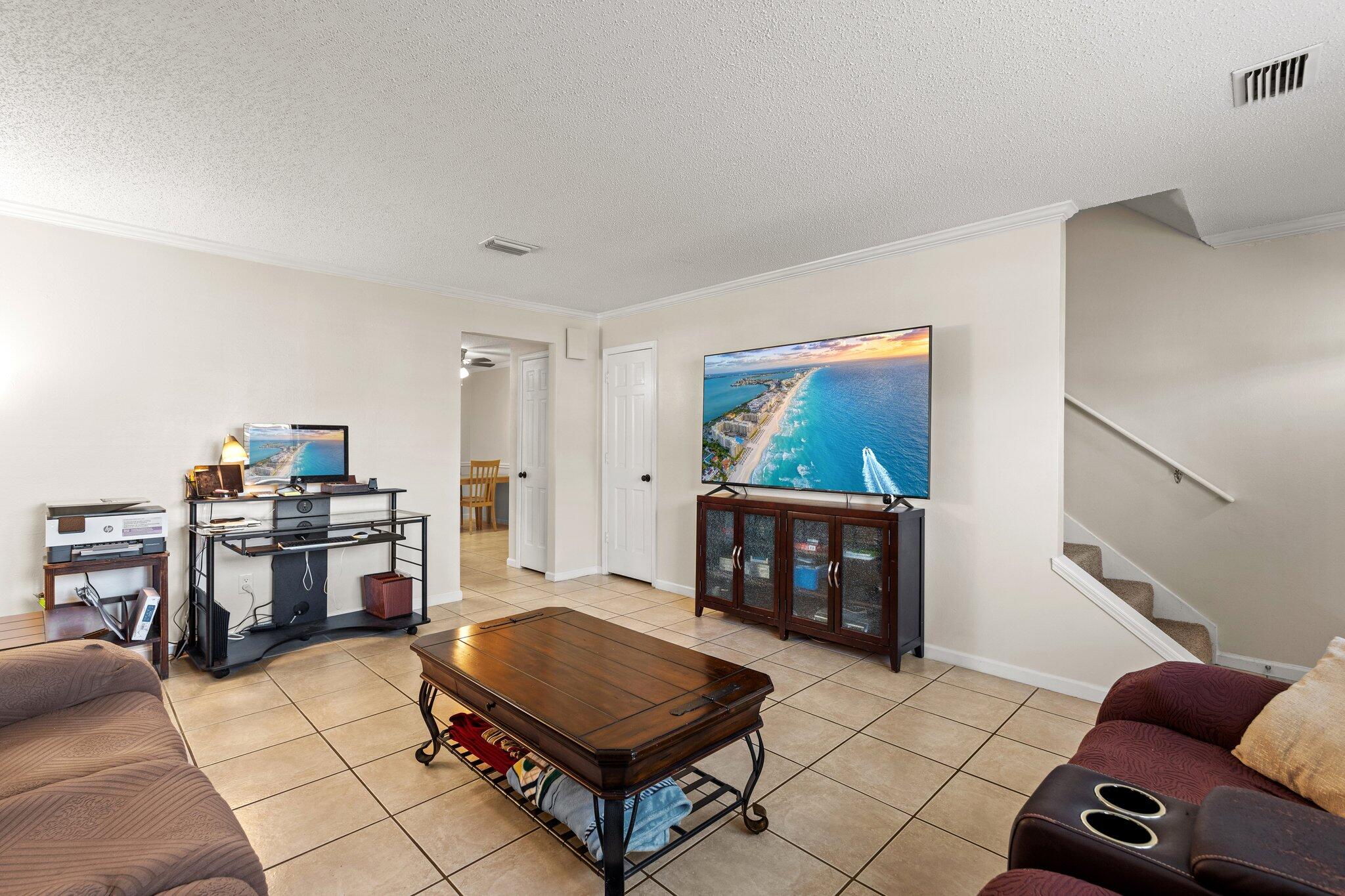 114 4th Avenue Shalimar, FL 32579 - Photo 6 of 59 a living room with furniture a flat screen tv and a stove
