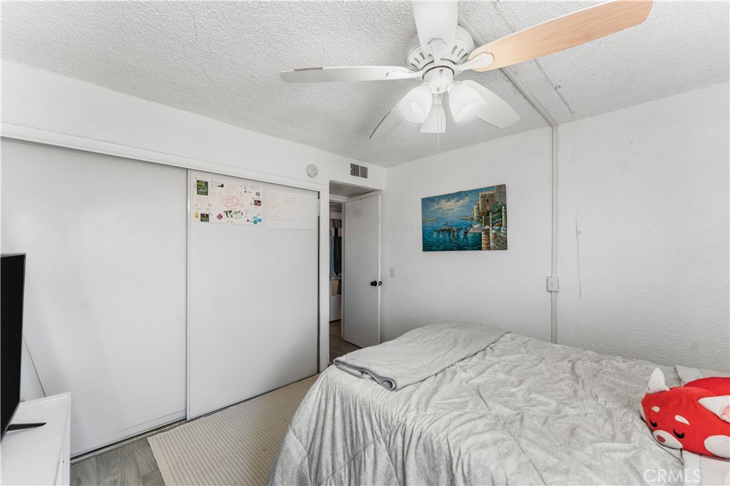 20116 Neuralia Road California City, CA 93505 - Photo 11 of 25 a bedroom with a bed and a ceiling fan