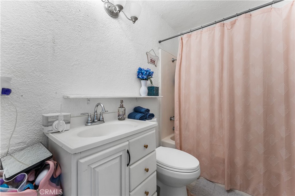 20116 Neuralia Road California City, CA 93505 - Photo 12 of 25 a bathroom with a sink toilet and a shower