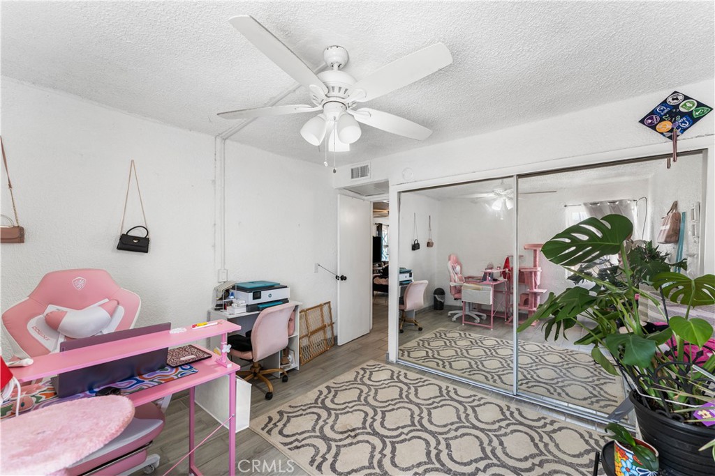 20116 Neuralia Road California City, CA 93505 - Photo 14 of 25 a bedroom with furniture and a potted plant