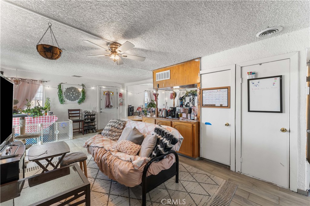 20116 Neuralia Road California City, CA 93505 - Photo 4 of 25 a living room with furniture a flat screen tv and a window