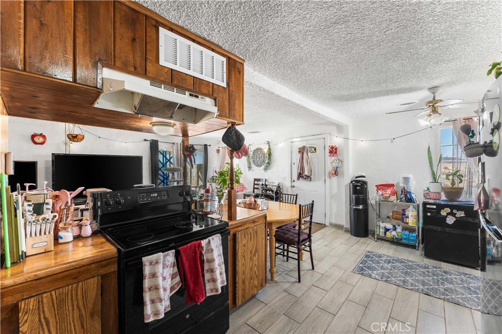 20116 Neuralia Road California City, CA 93505 - Photo 8 of 25 a living room with furniture and a flat screen tv