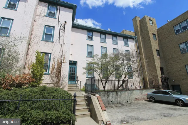 a front view of a house with parking