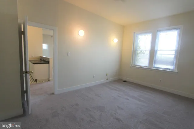 an empty room with windows and closet