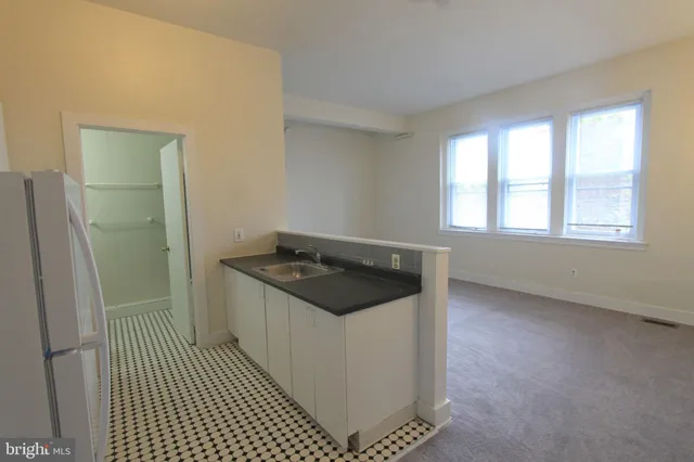 a kitchen with granite countertop a stove and a refrigerator