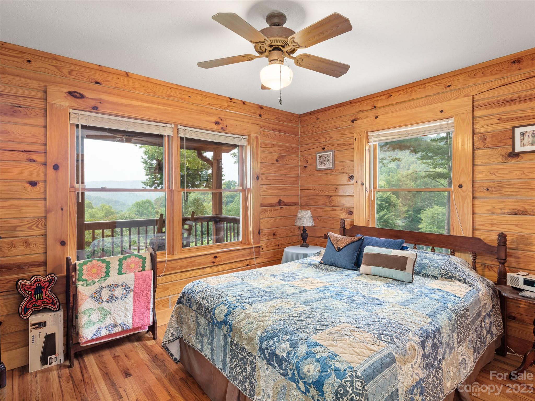 201 Staton Ridge Road Saluda, NC 28773 - Photo 22 of 32 a bedroom with a large bed and a large window