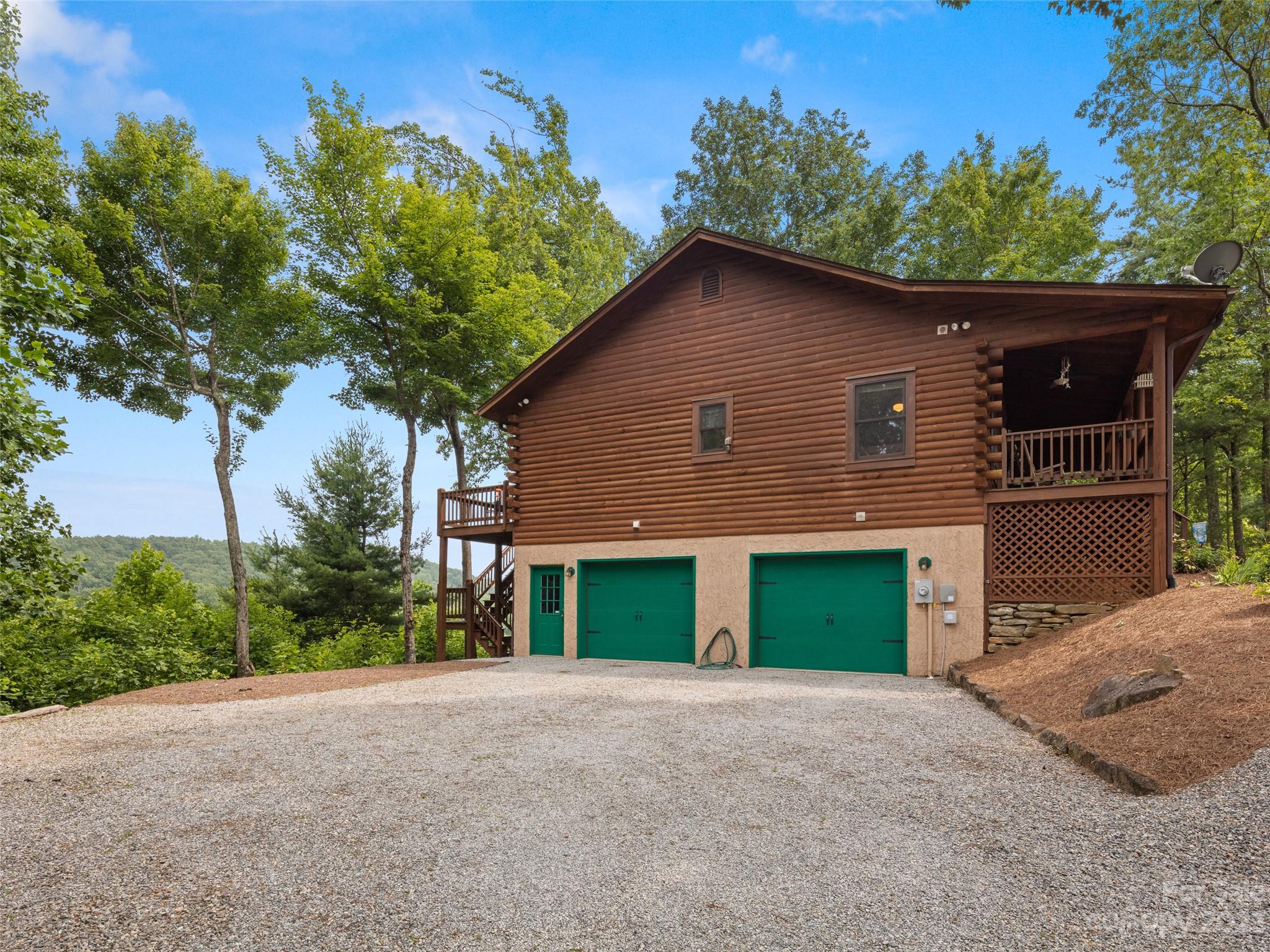 201 Staton Ridge Road Saluda, NC 28773 - Photo 26 of 32 a front view of a house with a yard and garage