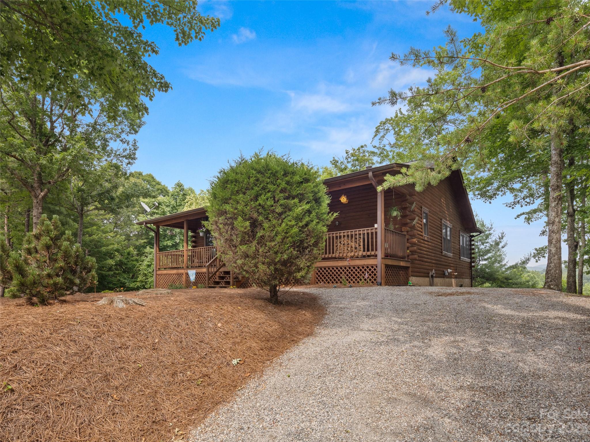 201 Staton Ridge Road Saluda, NC 28773 - Photo 3 of 32 a view of a house with a yard and garage