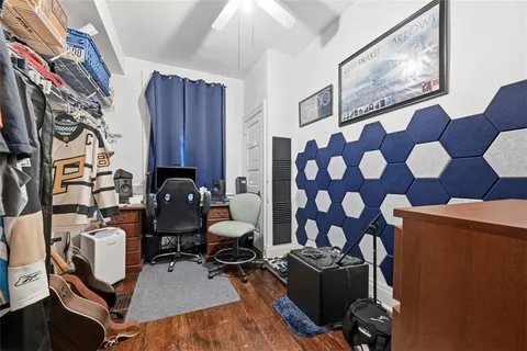 a living room with furniture and painting on the wall