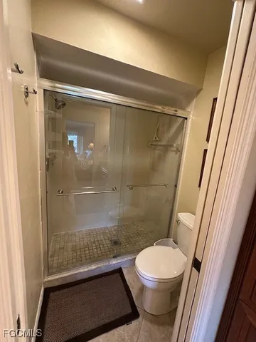 a bathroom with a toilet and a shower