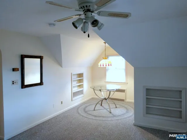 a view of a livingroom with furniture and a ceiling fan