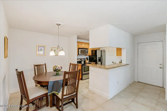 a view of kitchen and dining area with furniture