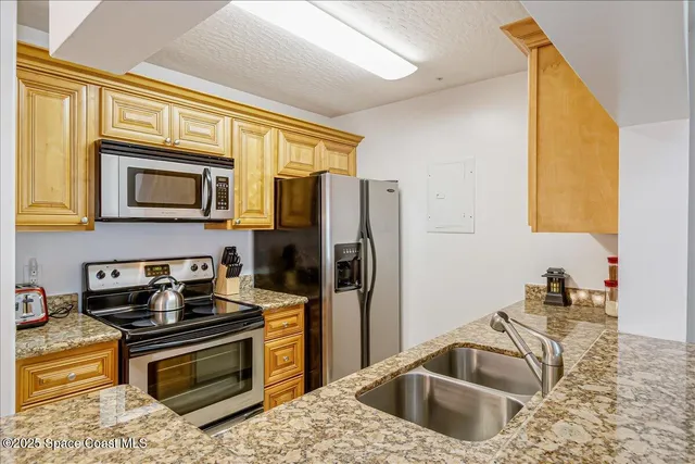 a kitchen with a sink stove and refrigerator