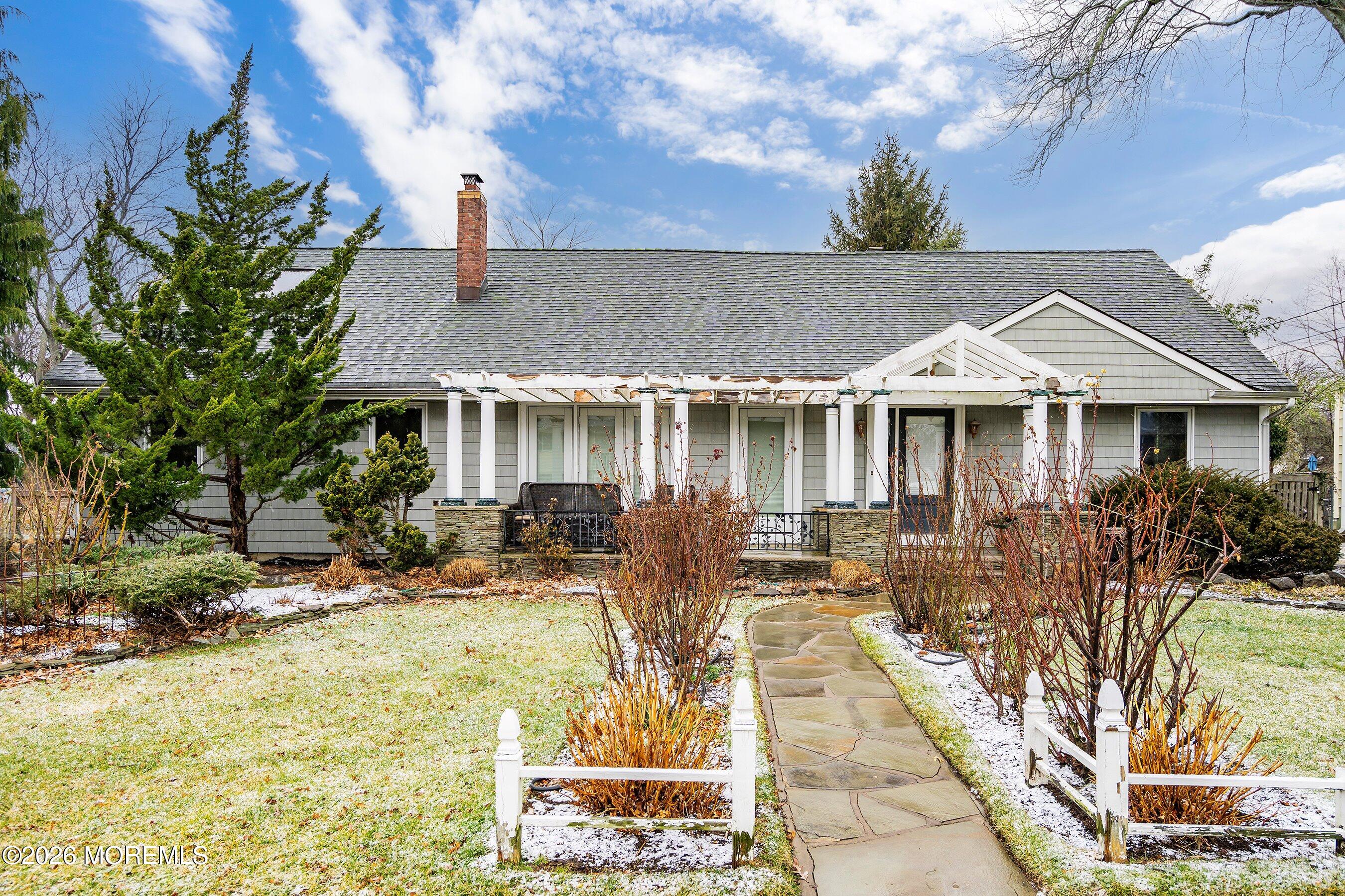 a front view of house with yard outdoor seating and barbeque oven