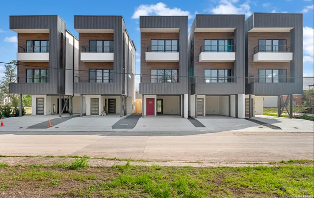 a view of a brick building next to a yard