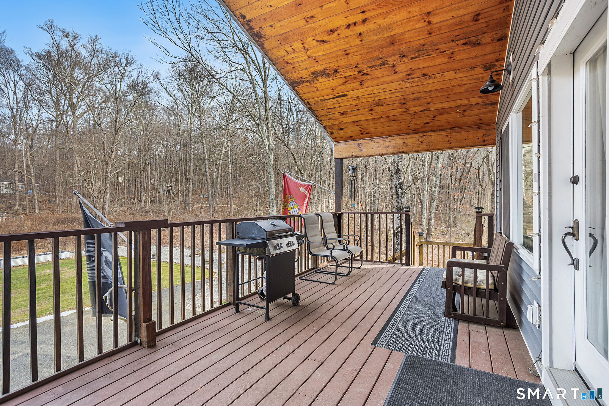 600 Woodtick Road Wolcott, CT 06716 - Photo 14 of 28 a balcony with wooden floor table and chairs