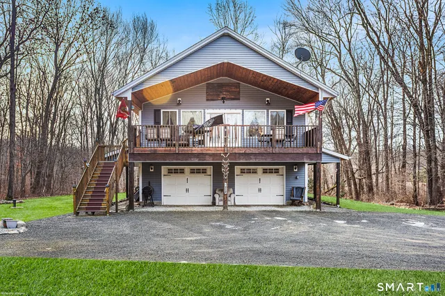 a front view of a house with swimming pool and porch