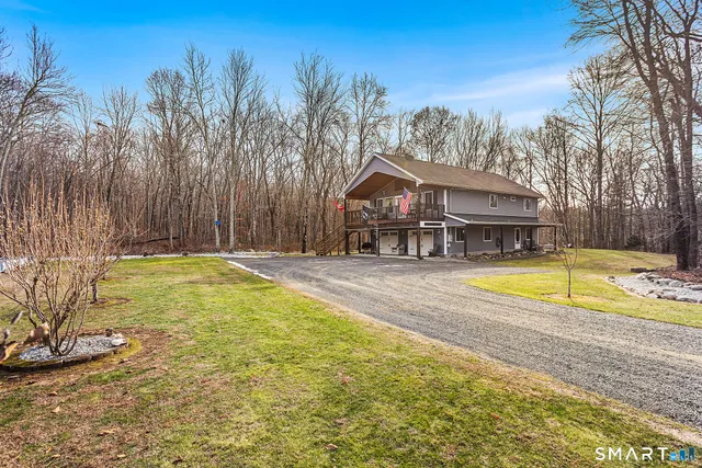 a view of a house with swimming pool and sitting area