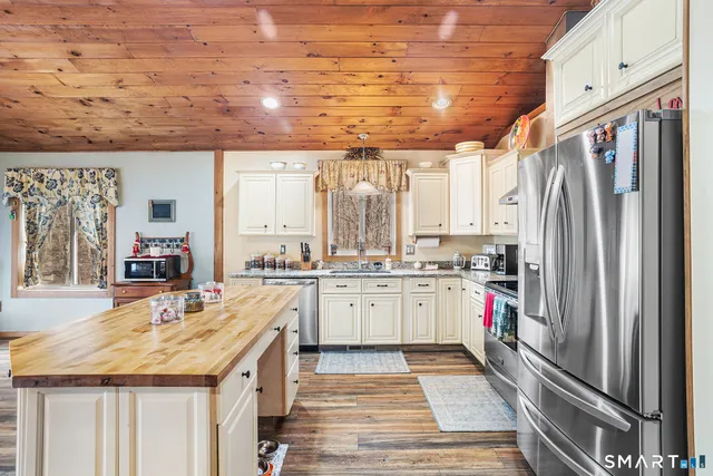 a kitchen with granite countertop a sink a stove and cabinets