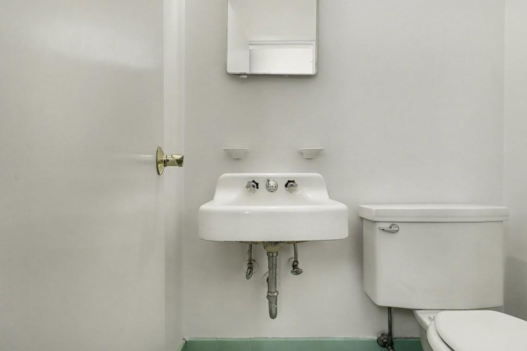2524 Asbury Court Decatur, GA 30033 - Photo 17 of 26 a bathroom with a sink a toilet and mirror