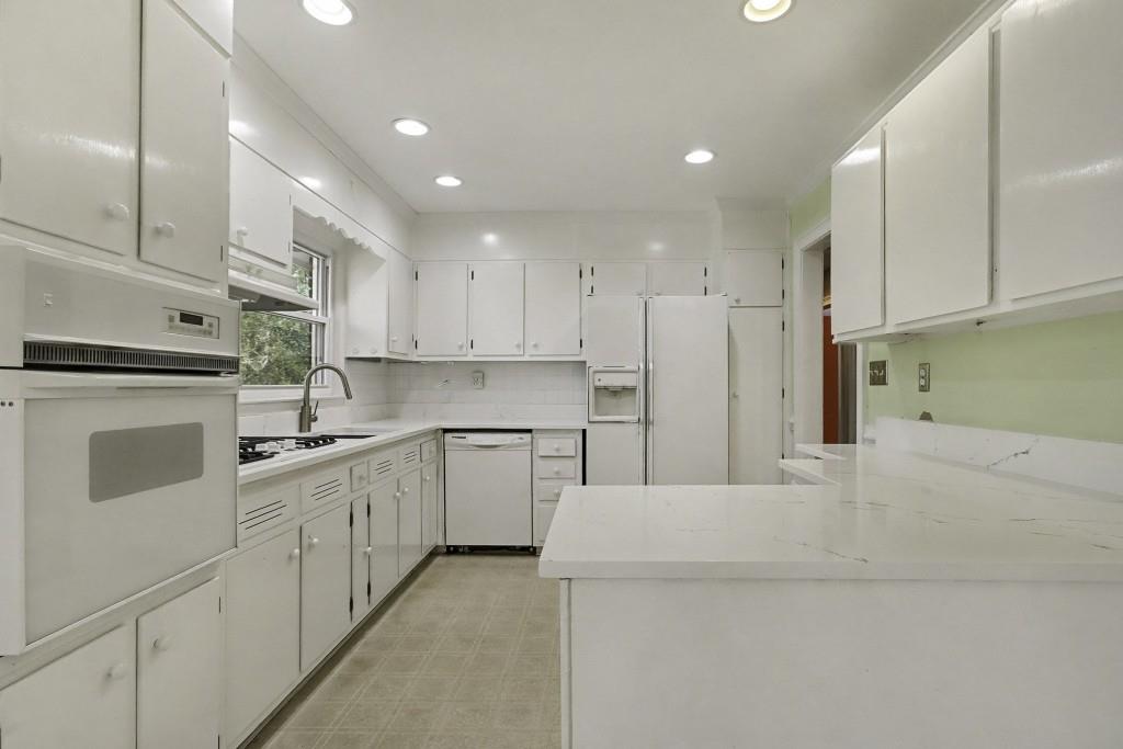 2524 Asbury Court Decatur, GA 30033 - Photo 3 of 26 a kitchen with cabinets and white stainless steel appliances