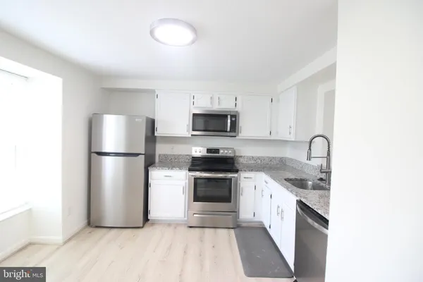 a kitchen with a sink and a stove
