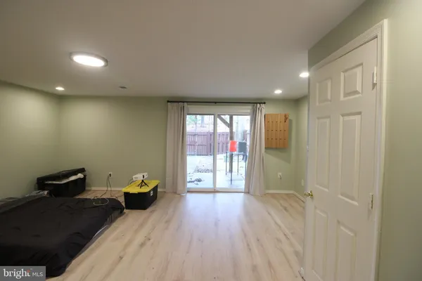 a view of a big room with wooden floor and windows