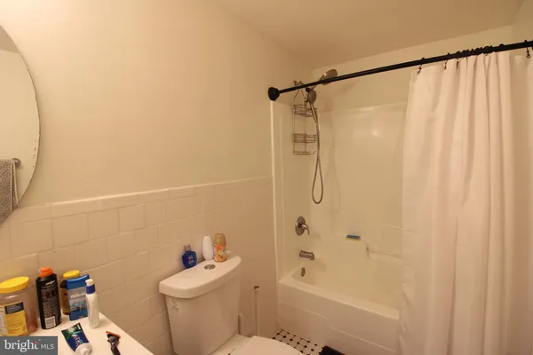 a bathroom with a shower a toilet and a sink