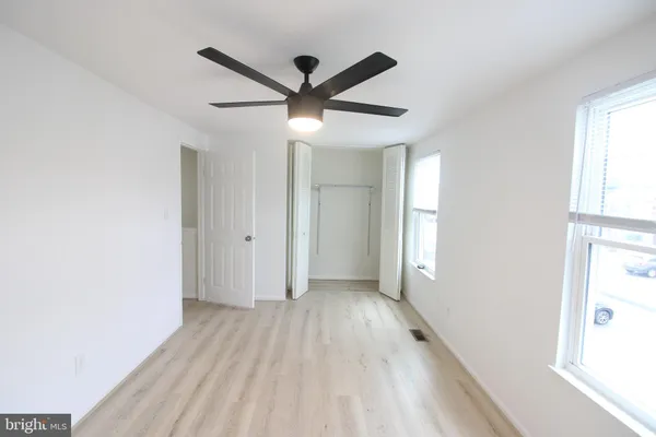 a view of a livingroom with a ceiling fan and window
