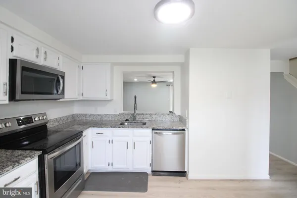 a kitchen with a sink stove and microwave