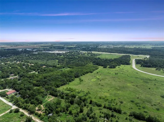 a view of a lush green outdoor space with a lake view