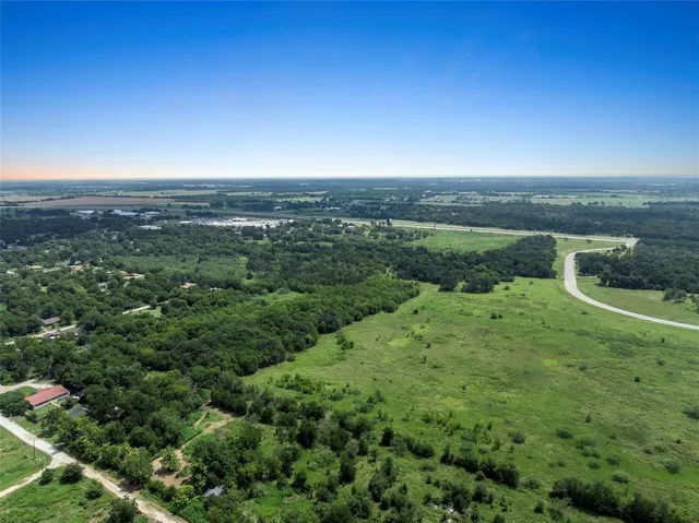 a view of a city with lush green forest