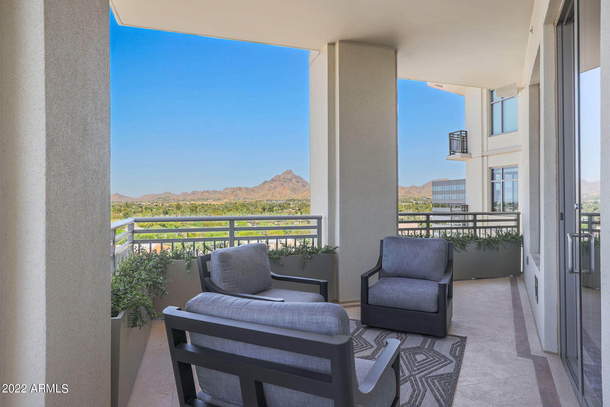 2211 East Camelback Road, Unit 1105/06 Phoenix, AZ 85016 - Photo 60 of 69 a view of a living room with furniture and a floor to ceiling window