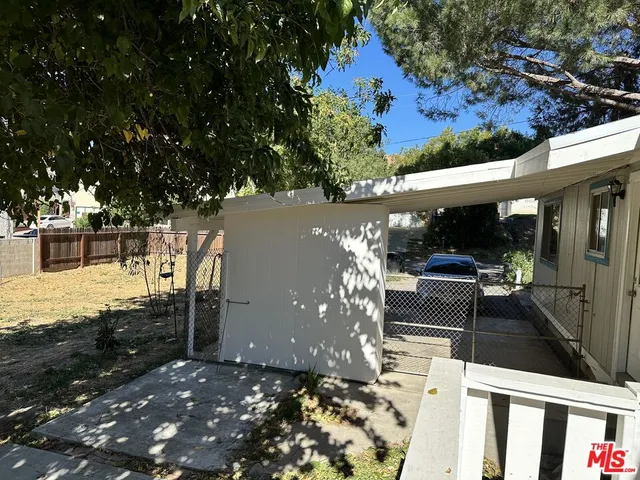 a view of a house with a tree in the yard