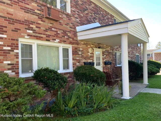 a view of a house with a yard and plants