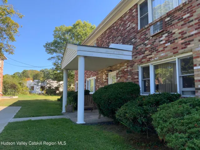 a view of a house with backyard and garden