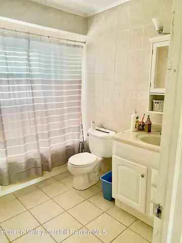 a bathroom with a toilet a sink and shower