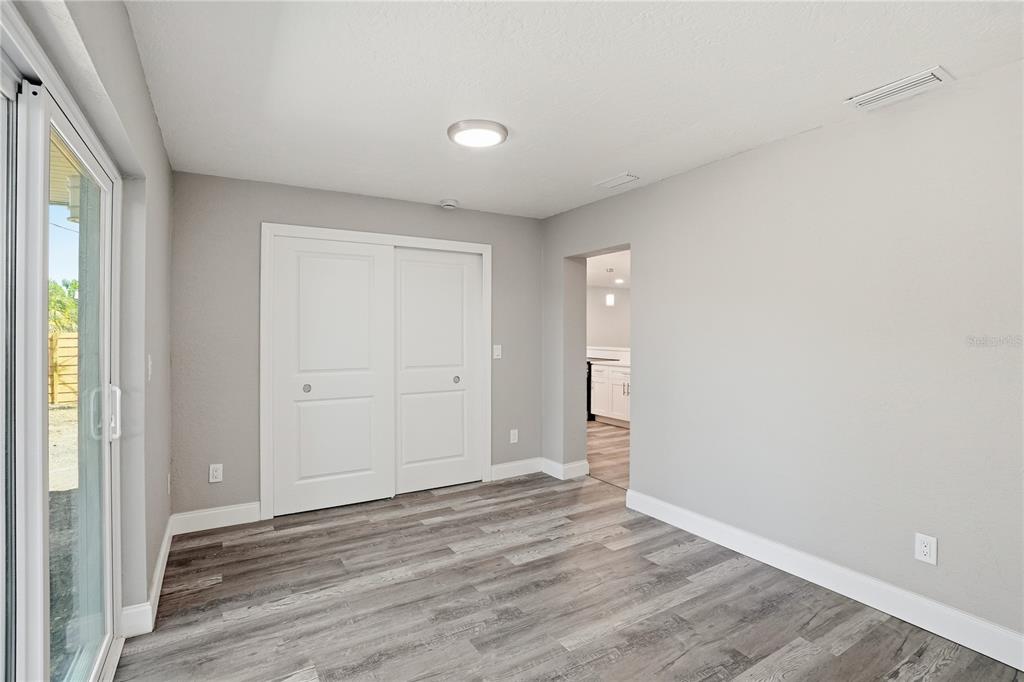 11525 81st Place Seminole, FL 33772 - Photo 19 of 24 a view of an empty room with wooden floor and a window