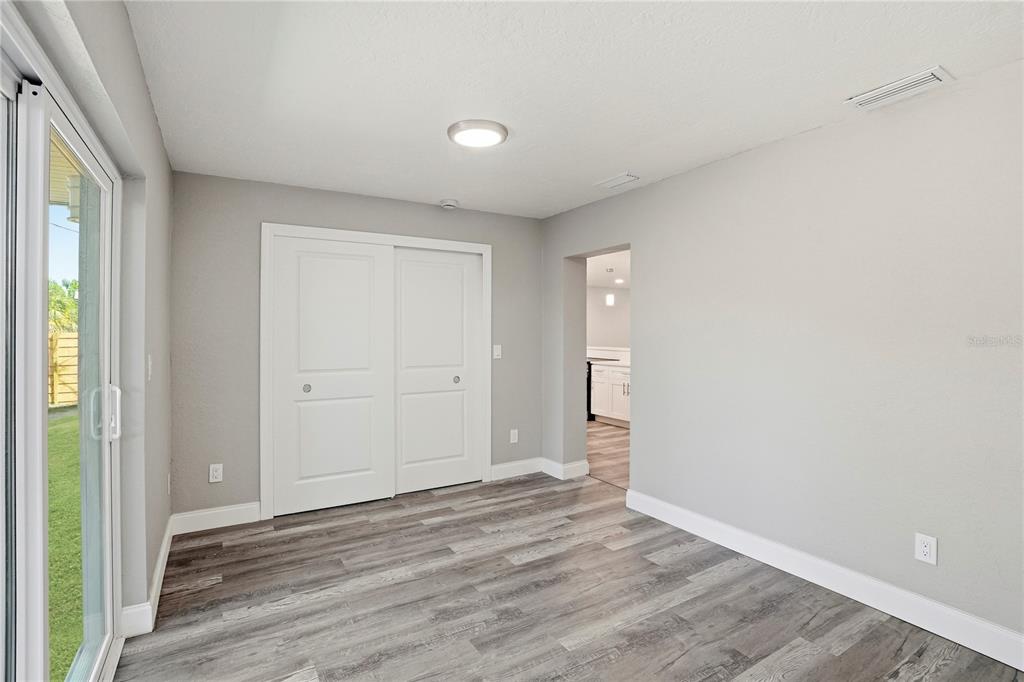 11525 81st Place Seminole, FL 33772 - Photo 20 of 24 a view of an empty room with wooden floor and a window