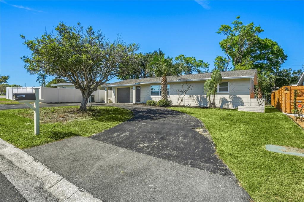 11525 81st Place Seminole, FL 33772 - Photo 2 of 24 a front view of a house with a yard and trees