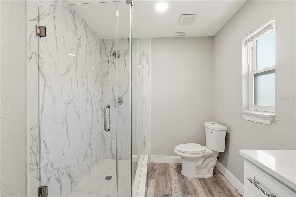 11525 81st Place Seminole, FL 33772 - Photo 22 of 24 a white toilet sitting next to a bathroom sink