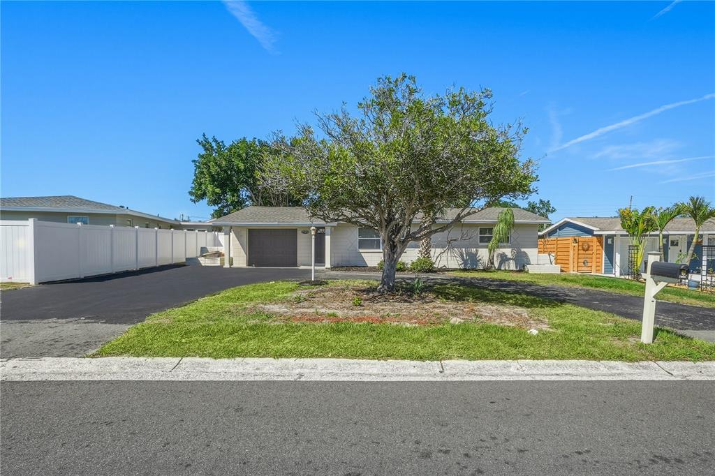 11525 81st Place Seminole, FL 33772 - Photo 3 of 24 a front view of a house with a yard and garage