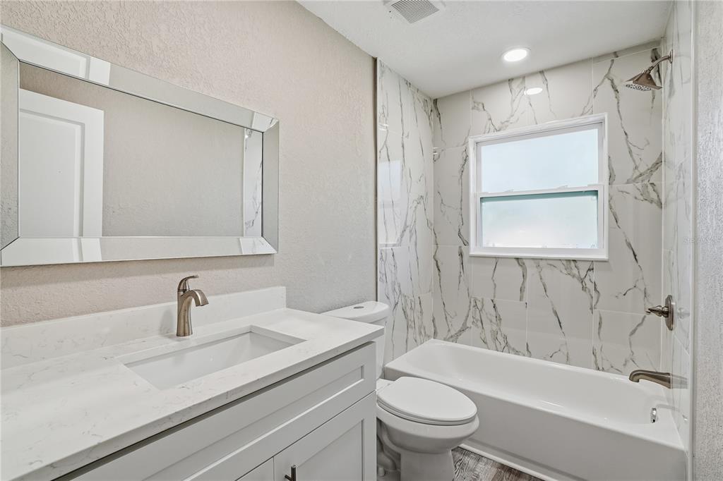 11525 81st Place Seminole, FL 33772 - Photo 4 of 24 a bathroom with a sink a toilet and shower