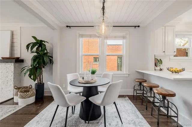 a view of a dining room with furniture window and flowerpot