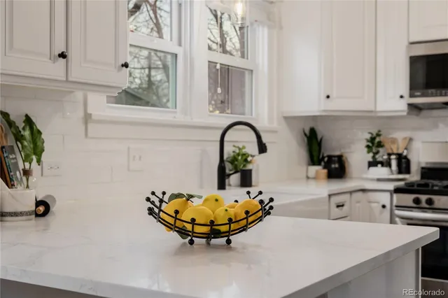 a kitchen with a sink a window and cabinets