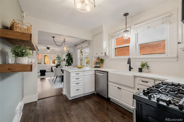 a kitchen with stainless steel appliances a stove and cabinets