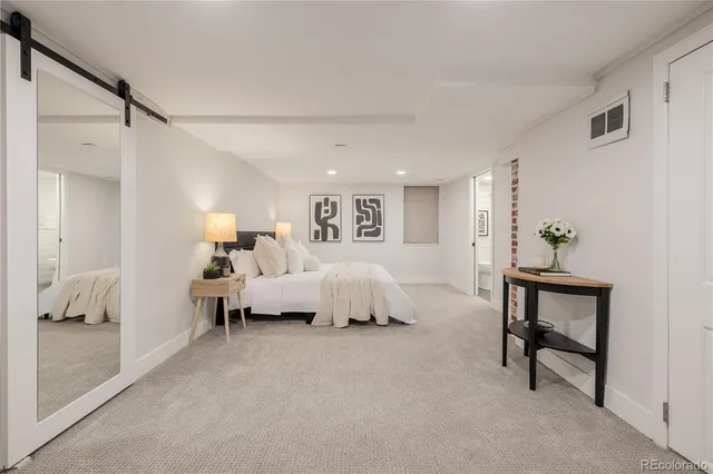 a bed room with a bed and a lamp