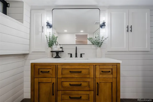 a bathroom with a sink a mirror and shower